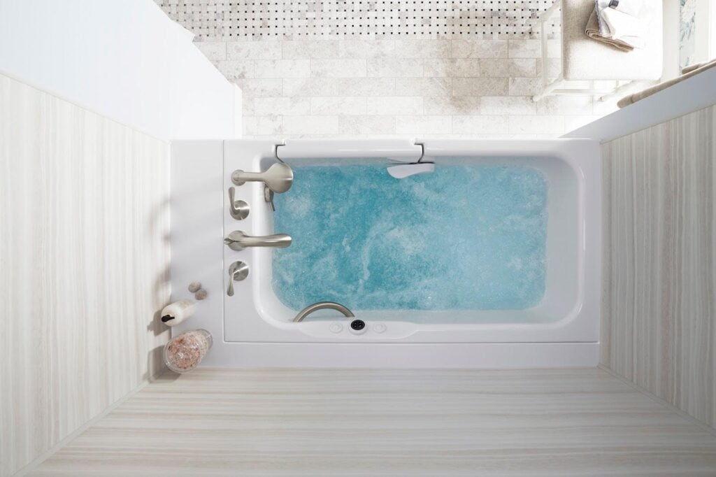Photo of a walk in tub that is filled with water and has the jets running